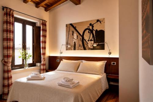 a bedroom with a bed with two towels on it at Boutique Rooms 3 0 in Ferrara