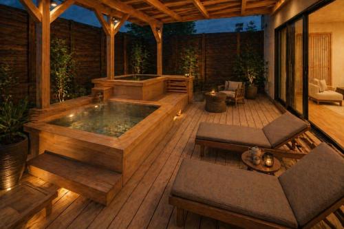 a jacuzzi tub on a wooden deck at 카미소 in Tsushima