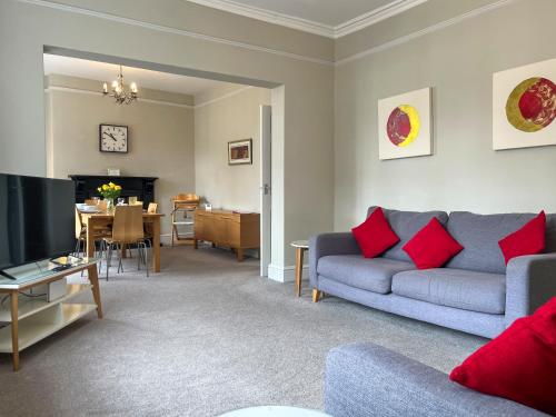 a living room with a couch and a television at Victoria Apartment 1 in Tarporley