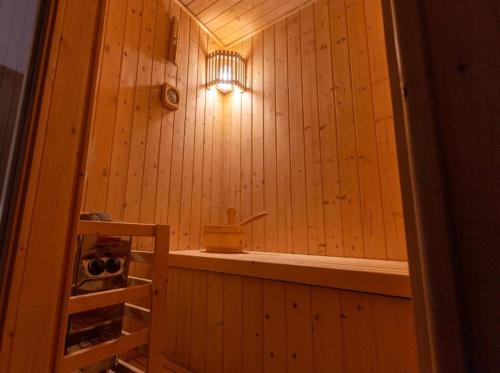 a small wooden room with a light on the wall at فندق الراية الفندقية in Jazan