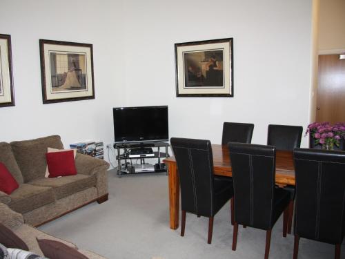 a living room with a table and chairs and a couch at Moat House 1 - Ukc4887 in Fort Augustus