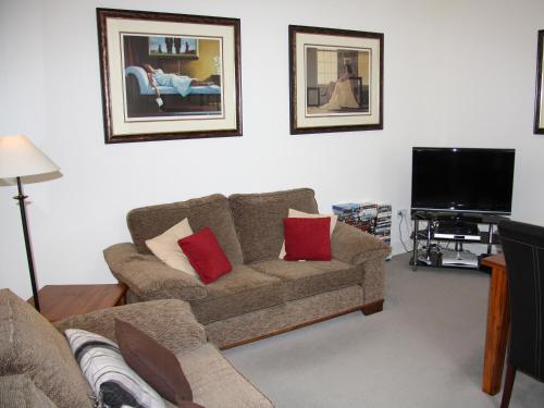 a living room with a couch and a flat screen tv at Moat House 1 - Ukc4887 in Fort Augustus