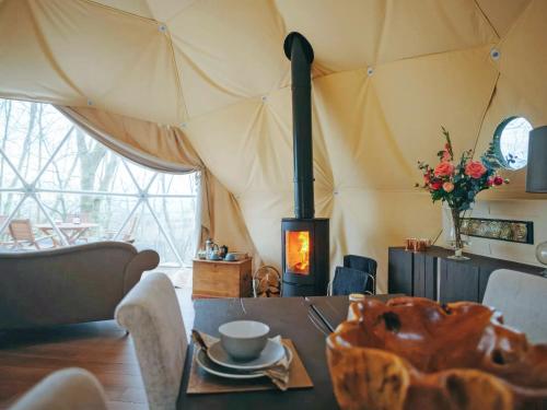 a living room with a fireplace in a tent at The Tree Dome - Ukc6979 in Ludlow