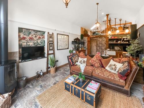 a living room with a couch and a fireplace at Bert's Barn in Firsby