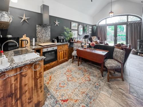 a kitchen with a table and a dining room at Bert's Barn in Firsby