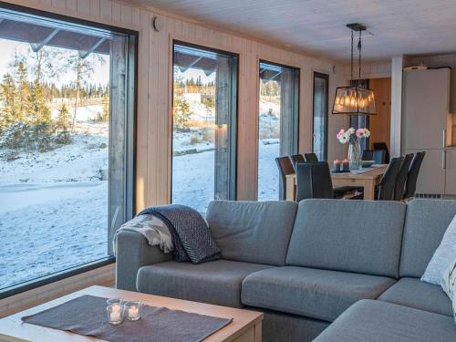a living room with a couch and a table and a window at 4 star holiday home in Øyer in Øyer