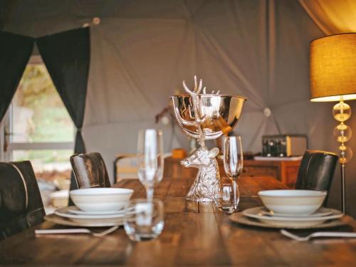 a wooden table with a bowl and glasses on it at The Star Dome - Ukc6978 in Ludlow