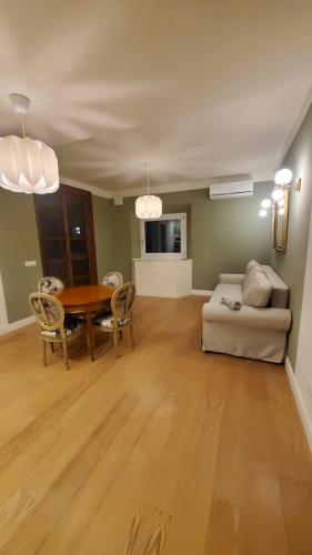 a living room with a table and a couch at Casa dì in Florence