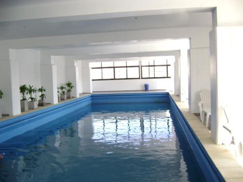 - Sala de estar con piscina y ventana grande en Grand Hotel by MH en Termas de Río Hondo