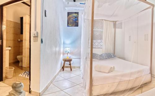 a bedroom with a canopy bed in a room at Villa Tewa in Mtwapa