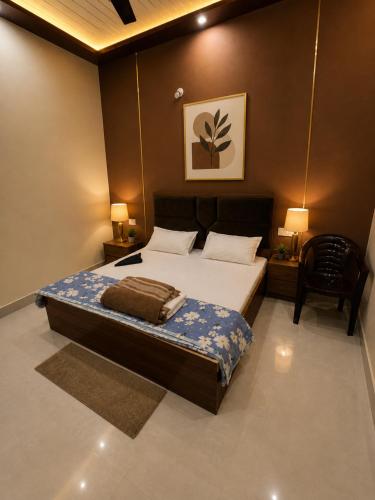 a bedroom with a large bed and a chair at Sudama Palace - Free Temple Pass For Guests in Ayodhya