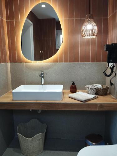 a bathroom with a sink and a mirror at Gaia in Posidhonía