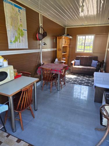a room with a table and chairs and a couch at Pole biwakowe U Marcina in Kwidzyn
