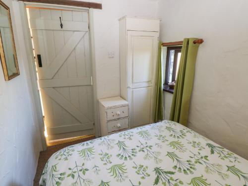 a bedroom with a bed and a closet with a door at Ramsgrove in Swansea