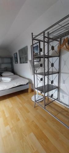 a bedroom with a bunk bed and a wooden floor at Studio Arc en Ciel in Bouguenais