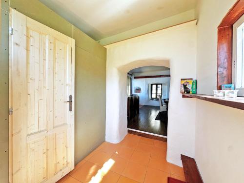a hallway with a door and a living room at Ziggiho chalupa in Pliešovce