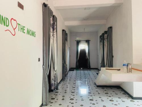 a hallway with a sign that reads end the mongos at MOMS Villa in Arugam Bay