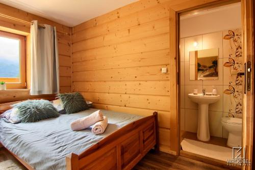 a bedroom with a bed and a toilet and a sink at Noclegi u Gabrysi in Kościelisko