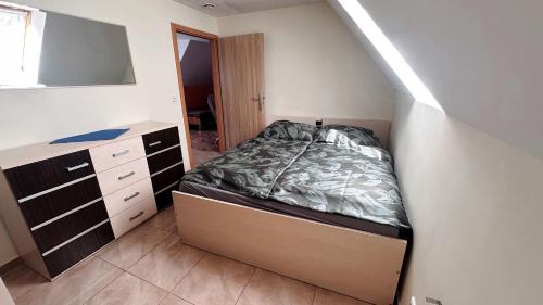 a bedroom with a bed and a dresser and a mirror at Agroturystyka Düsselkamp Tumiany in Barczewo
