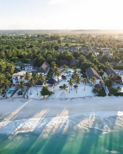 an aerial view of a beach with palm trees and houses at Protels La Plage Resort in Bwejuu