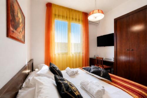 a bedroom with a white bed with pillows on it at Le Chele - A Due Passi dal Mare in Torre Lapillo
