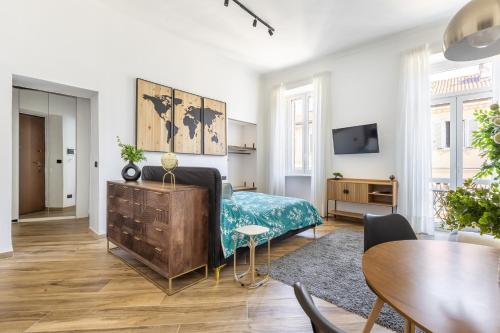 a bedroom with a bed and a table and chairs at Le Monde Luxury Apartment in Turin