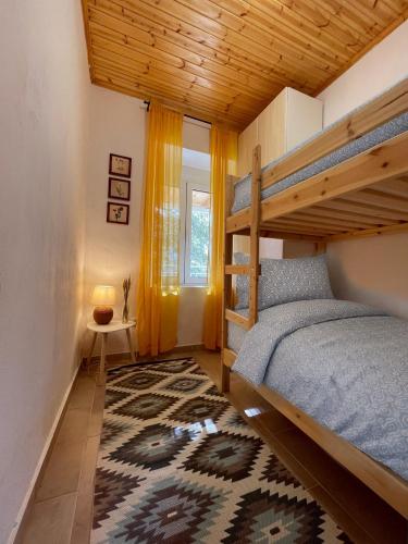 a bedroom with a bunk bed and a rug at Taygetos hut in Dhirrákhion