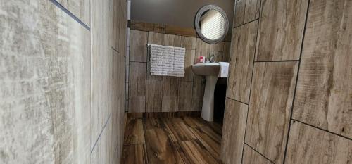 a bathroom with a sink and a mirror at Crayfish Creek Guest House in Richards Bay
