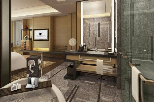 a bathroom with a tub and a sink and a bath tub at JW Marriott Hotel Xi'an in Xi'an