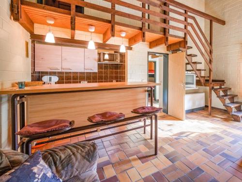 a large kitchen with a counter and a table at Cosy holiday home in the Hochsauerland with terrace at the edge of the forest in Schmallenberg