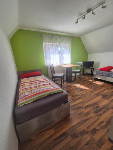 a bedroom with a bed and a table and chairs at Zimmervermietung Müller in Kelheim
