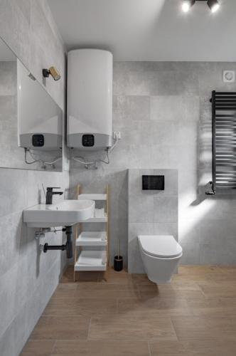 a bathroom with a sink and a toilet at Osada Jackowo in Jarosławiec