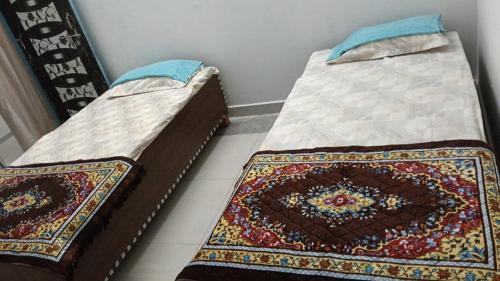two beds sitting next to each other in a room at Hotel Vasu in Gopālganj