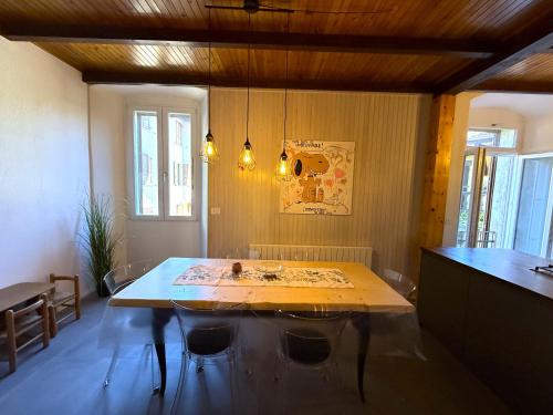 a dining room with a table and some chairs at Casa Claudia Pieve centro storico in Tremosine Sul Garda