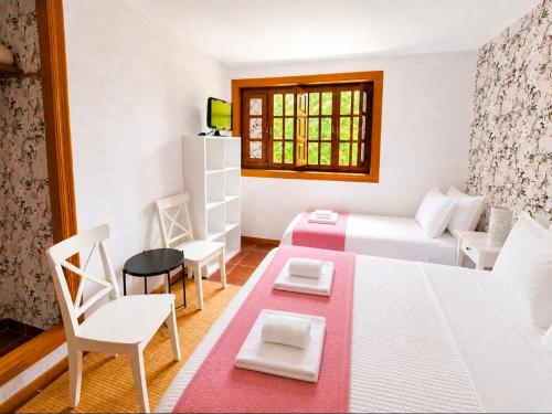 a small room with a bed and a table and chairs at Posada Adela in Santillana del Mar
