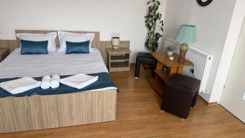 a bedroom with a bed with two pairs of shoes on it at Casa Ramona in Turda