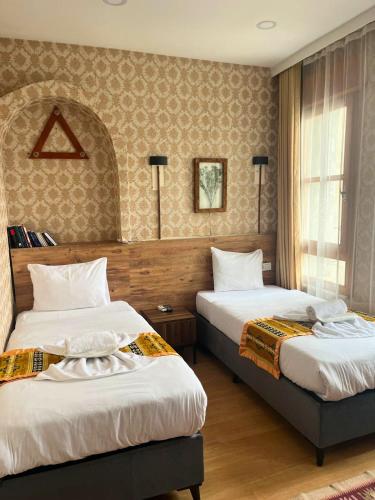 a hotel room with two beds and a window at Otantik Hotel in Istanbul