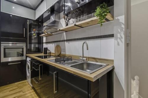 a kitchen with a sink and a stove at Riverside Crossing in Worcester