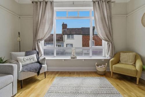 a living room with a window and a couch and chairs at Riverside Crossing in Worcester