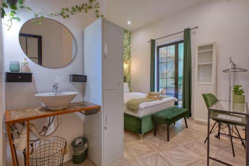 a bathroom with a sink and a mirror at Eclectic Maisonette in Luqa in Luqa