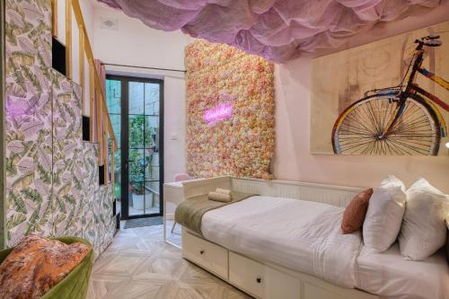 a bedroom with a bed with a bike on the wall at Eclectic Maisonette in Luqa in Luqa