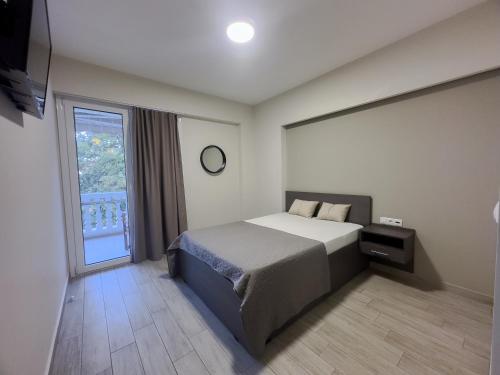 a bedroom with a bed and a large window at Casa Di Mare II in Olympic Beach