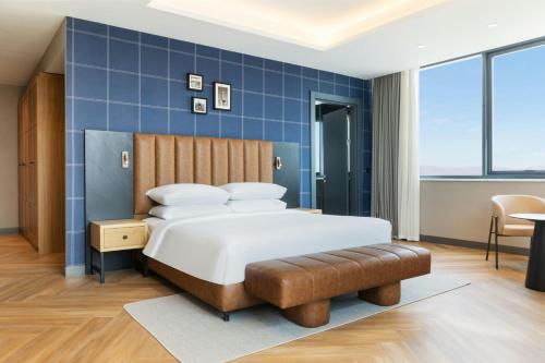 a bedroom with a bed and a blue wall at Four Points by Sheraton Elazig in Elazığ