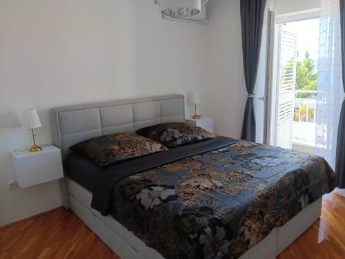 a bedroom with a bed with a large window at Hanna in Dramalj