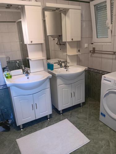 a bathroom with two sinks and a toilet at Hanna in Dramalj