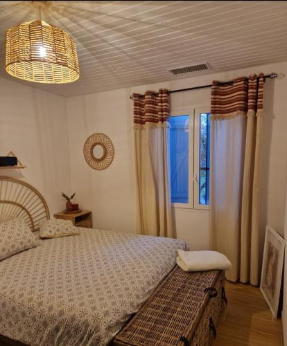 a bedroom with a bed and a window at Propriété avec piscine in Vensac