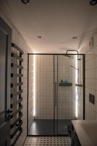 a shower with a glass door in a bathroom at Apartmán Pradědův in Šumperk