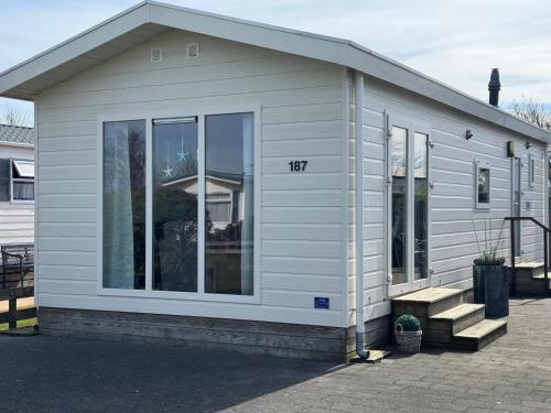 ein kleines Haus mit der Hausnummer darauf in der Unterkunft J 187 in Petten