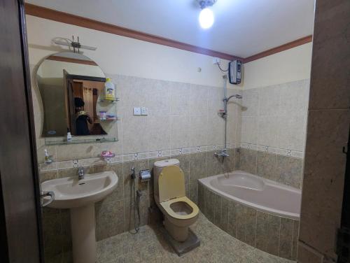 a bathroom with a sink and a toilet and a tub at Arangala View in Elhanyaya