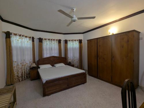 a bedroom with a bed and a ceiling fan at Arangala View in Elhanyaya